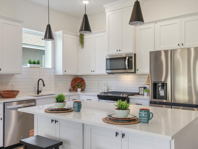930 Mansfield St, Houston, TX 77091 - kitchen with appliances with stainless steel finishes, a center island, decorative backsplash, and white cabinets