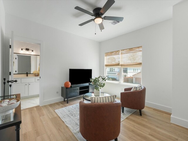 930 Mansfield St, Houston, TX 77091 - living area featuring baseboards, a ceiling fan, and light wood-style floors