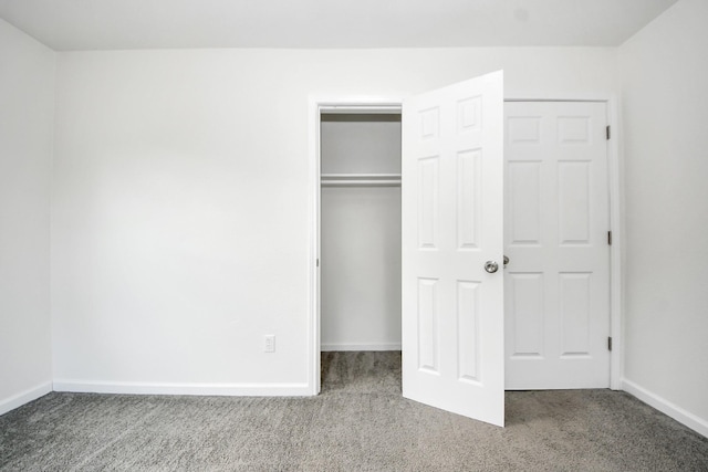 unfurnished bedroom featuring carpet flooring, a closet, and baseboards