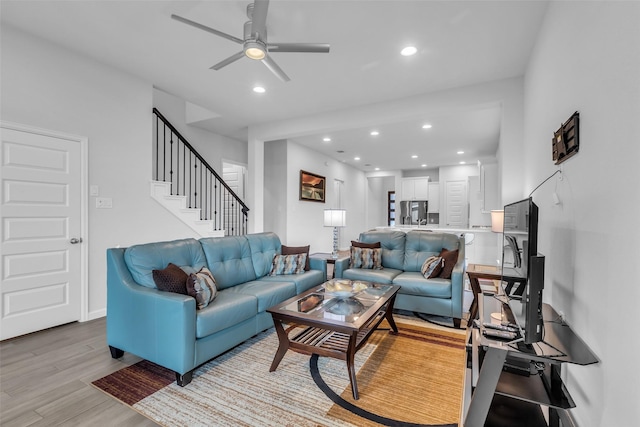 11822 Radura Rd, Humble, TX 77346 - living area with ceiling fan, light wood finished floors, recessed lighting, and stairs