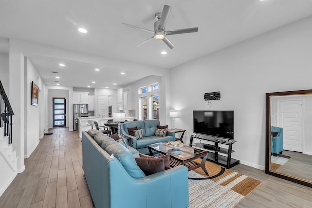 11822 Radura Rd, Humble, TX 77346 - living room with stairs, light wood-style flooring, baseboards, and recessed lighting