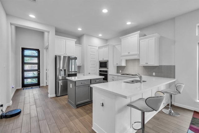 11822 Radura Rd, Humble, TX 77346 - kitchen with stainless steel appliances, a sink, wood finished floors, baseboards, and recessed lighting