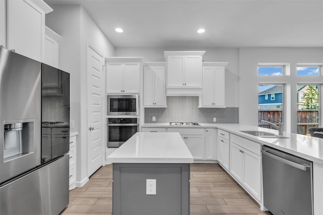 11822 Radura Rd, Humble, TX 77346 - kitchen featuring stainless steel appliances, a sink, recessed lighting, light countertops, and decorative backsplash