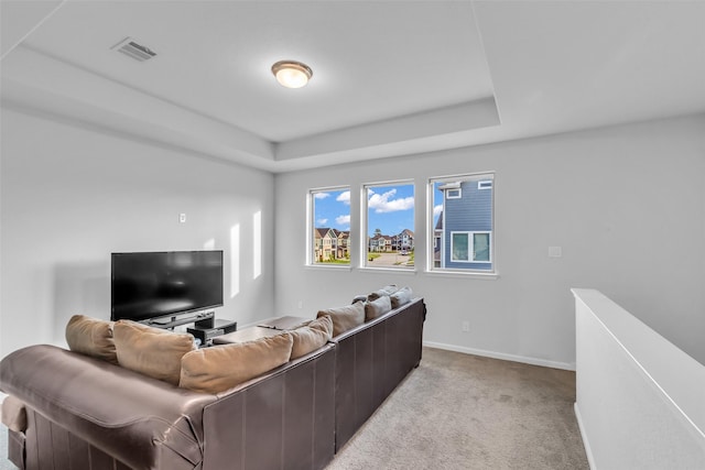 11822 Radura Rd, Humble, TX 77346 - living room with light colored carpet, a tray ceiling, and baseboards