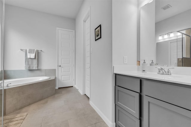 11822 Radura Rd, Humble, TX 77346 - bathroom featuring a garden tub, vanity, and tile patterned floors