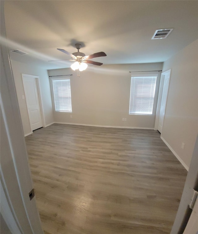 419 8th Ave N, Texas City, TX 77590 - spare room with wood finished floors, ceiling fan, and baseboards