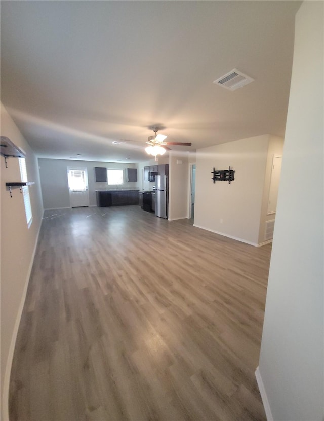 419 8th Ave N, Texas City, TX 77590 - unfurnished living room with baseboards, wood finished floors, and a ceiling fan