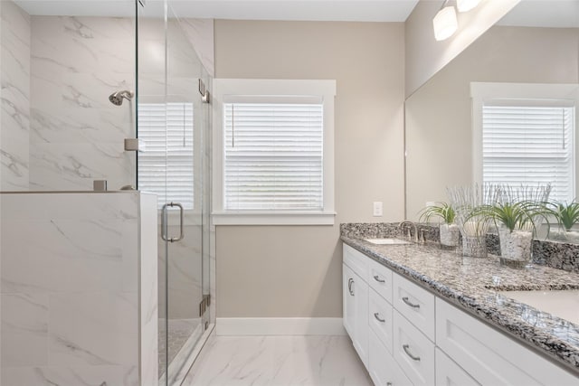 2714 Gano St, Houston, TX 77009 - bathroom featuring marble look tile flooring, a marble finish shower, double vanity, and baseboards