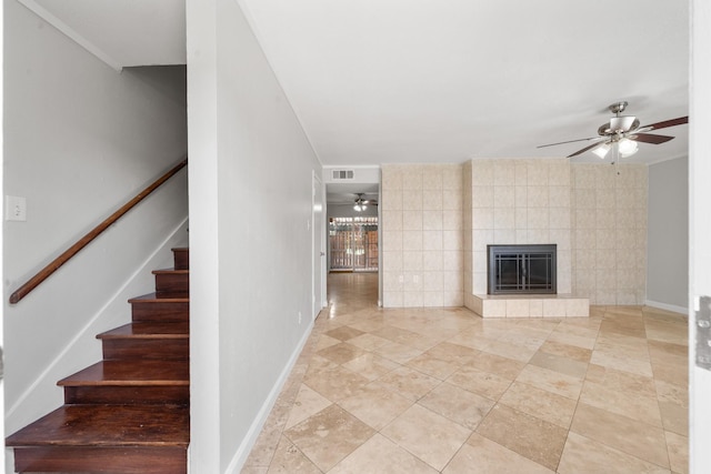 4166 Belle Park Dr Unit 4166, Houston, TX 77072 - unfurnished living room featuring a ceiling fan, stairway, a tiled fireplace, and baseboards