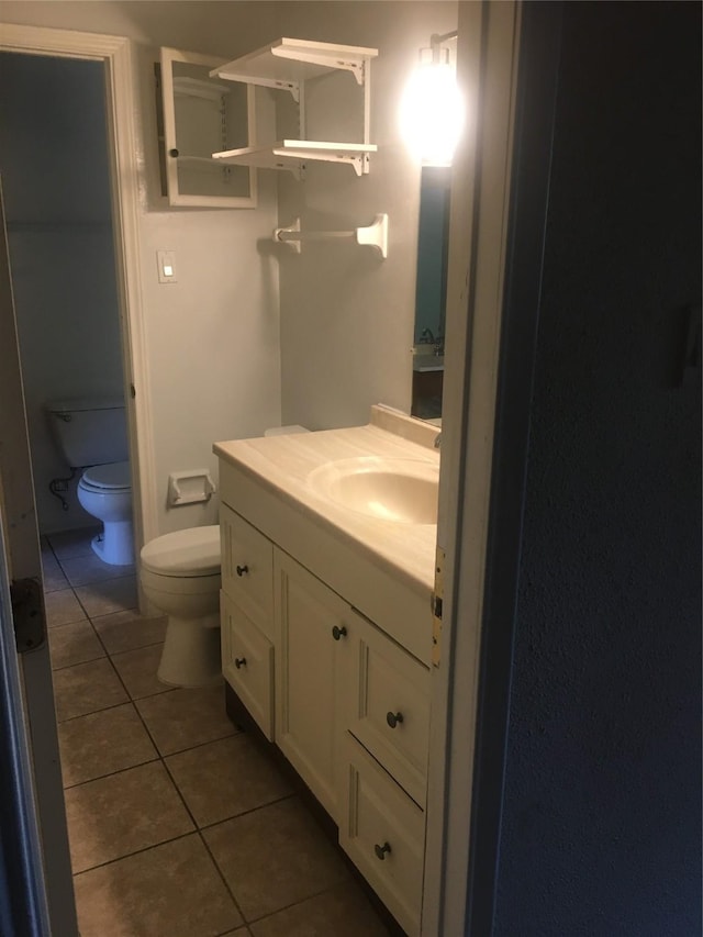 6211 Fondren Rd Unit 25, Houston, TX 77036 - bathroom featuring toilet, tile patterned flooring, and vanity