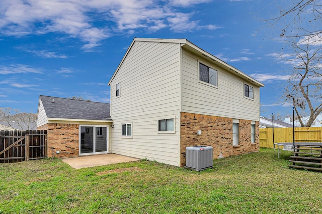 2526 Windswept Dr, Richmond, TX 77406 - back of property with brick siding, a trampoline, central air condition unit, a patio area, and roof with shingles