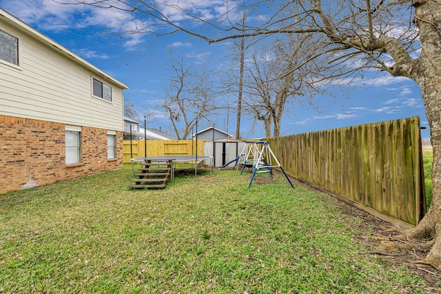2526 Windswept Dr, Richmond, TX 77406 - view of yard featuring a trampoline, a shed, an outbuilding, and a playground