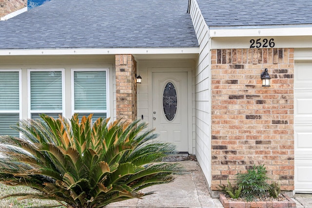2526 Windswept Dr, Richmond, TX 77406 - property entrance featuring roof with shingles and brick siding