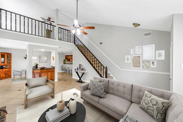 2526 Windswept Dr, Richmond, TX 77406 - living area featuring light tile patterned flooring, stairway, a ceiling fan, and high vaulted ceiling