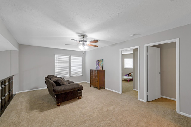 2526 Windswept Dr, Richmond, TX 77406 - sitting room with light colored carpet, ceiling fan, baseboards, and a textured ceiling