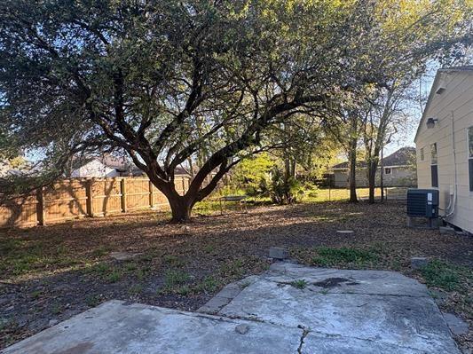 6240 25th St, Groves, TX 77619 - view of yard with a patio area, fence, and cooling unit