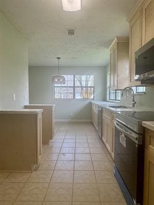 612 S 15th St, Nederland, TX 77627 - kitchen featuring stainless steel appliances, light countertops, a sink, light tile patterned floors, and hanging light fixtures