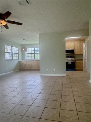 612 S 15th St, Nederland, TX 77627 - unfurnished living room with baseboards, ceiling fan, and light tile patterned floors