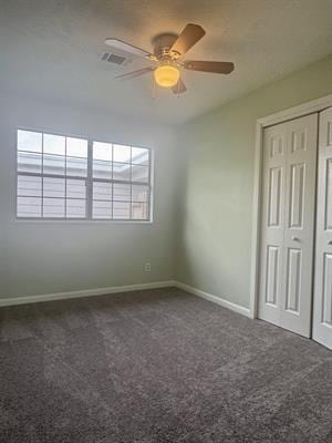 612 S 15th St, Nederland, TX 77627 - unfurnished bedroom featuring carpet floors, baseboards, a closet, and ceiling fan