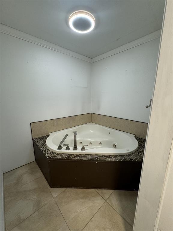 401 Henry St, Bridge City, TX 77611 - full bath with a whirlpool tub, crown molding, and tile patterned flooring