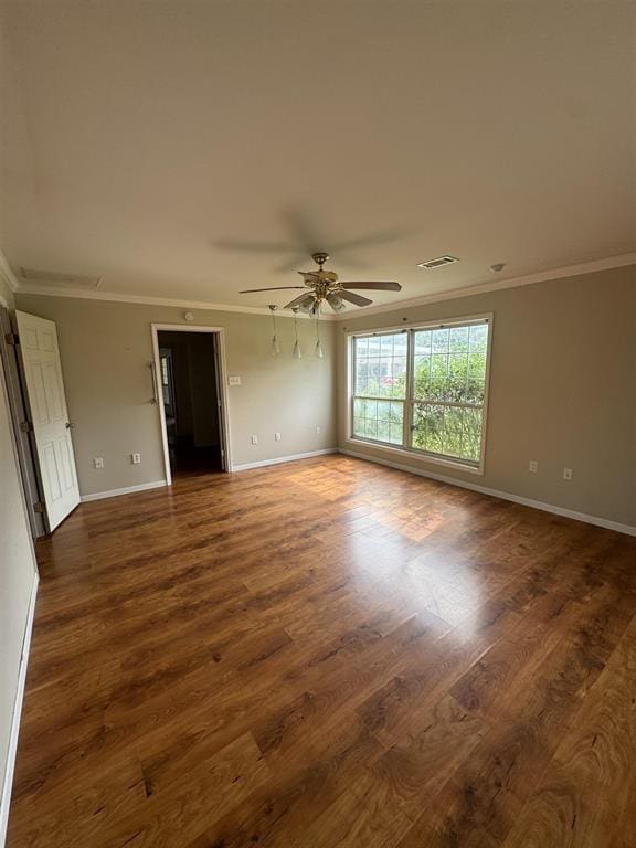 401 Henry St, Bridge City, TX 77611 - empty room with ornamental molding, baseboards, dark wood-style floors, and ceiling fan