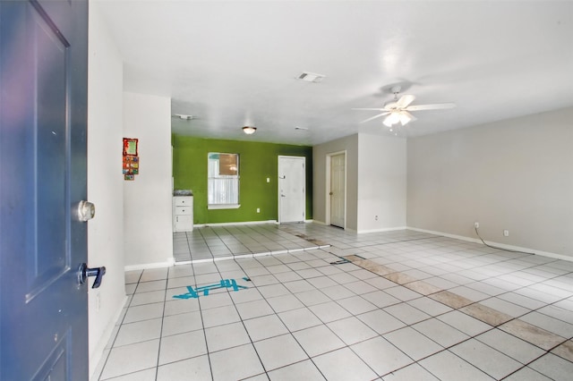 1911 Thonig Rd, Houston, TX 77055 - spare room with light tile patterned flooring, a ceiling fan, and baseboards