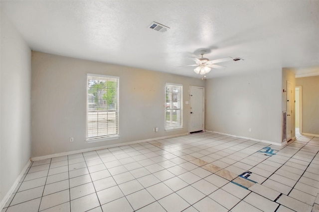 1911 Thonig Rd, Houston, TX 77055 - unfurnished room featuring a ceiling fan, light tile patterned floors, and baseboards