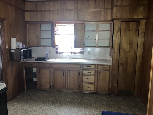 1401 8th St, Bay City, TX 77414 - kitchen featuring a sink, light countertops, an office area, and wood walls