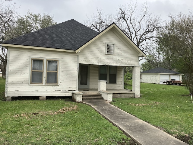 1401 8th St, Bay City, TX 77414 - view of front facade with covered porch, roof with shingles, and a front yard