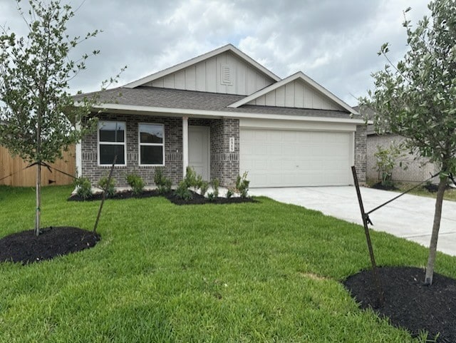 281 Douglas Hills Dr, Magnolia, TX 77354 - view of front of home with board and batten siding, a garage, concrete driveway, brick siding, and a front lawn