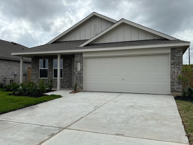 281 Douglas Hills Dr, Magnolia, TX 77354 - view of front of home with board and batten siding, concrete driveway, brick siding, and a garage