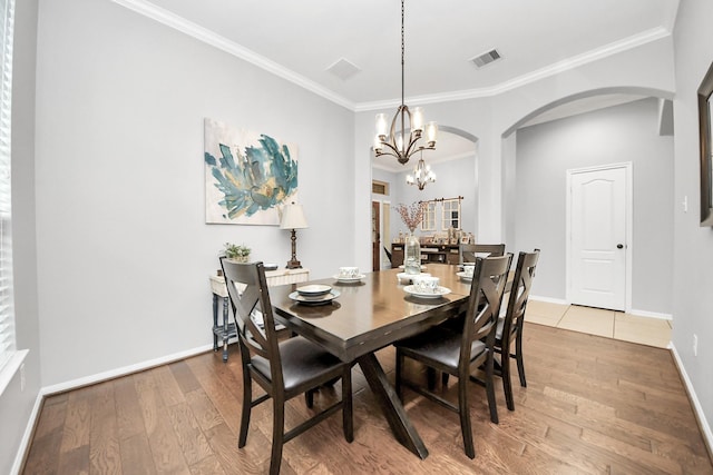 419 Sunny River Ln, Richmond, TX 77406 - dining space with arched walkways, a chandelier, hardwood / wood-style floors, ornamental molding, and baseboards