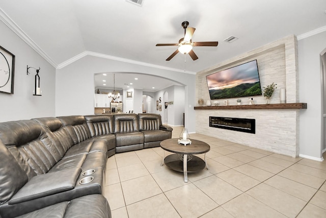 419 Sunny River Ln, Richmond, TX 77406 - living room with arched walkways, a ceiling fan, light tile patterned floors, crown molding, and a large fireplace