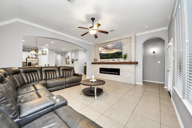 419 Sunny River Ln, Richmond, TX 77406 - living room with arched walkways, a large fireplace, a ceiling fan, light tile patterned flooring, and baseboards