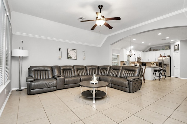 419 Sunny River Ln, Richmond, TX 77406 - living room featuring a ceiling fan, vaulted ceiling, light tile patterned floors, arched walkways, and baseboards