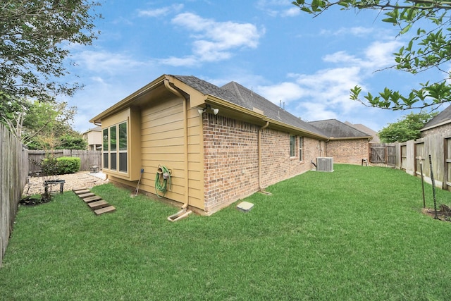 419 Sunny River Ln, Richmond, TX 77406 - view of home's exterior featuring central AC, brick siding, and a shingled roof