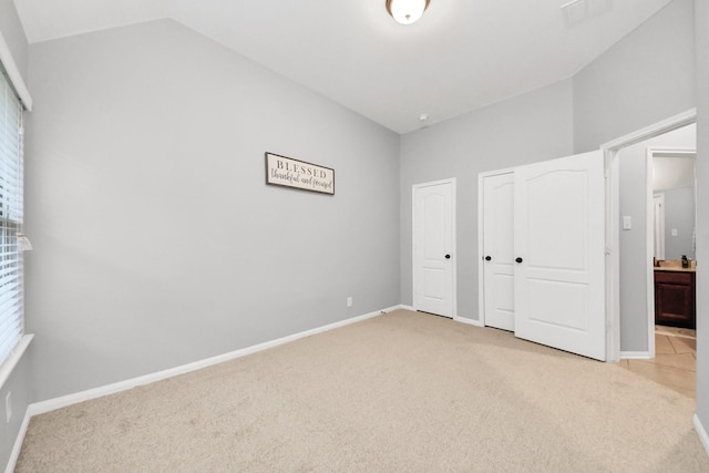 419 Sunny River Ln, Richmond, TX 77406 - unfurnished bedroom with light carpet, vaulted ceiling, two closets, and baseboards
