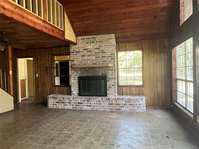 101 Hidden Cove Dr, Point Blank, TX 77364 - unfurnished living room with wooden ceiling, wooden walls, ceiling fan, a fireplace, and vaulted ceiling