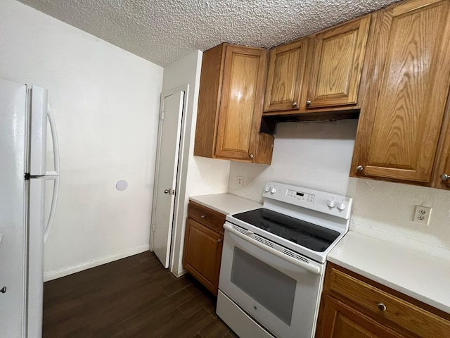 6343 Glenhagen Dr, Houston, TX 77084 - kitchen featuring white appliances, brown cabinetry, dark wood-type flooring, light countertops, and a textured ceiling