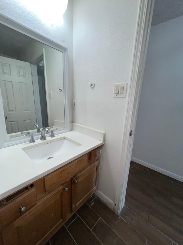 6343 Glenhagen Dr, Houston, TX 77084 - bathroom with baseboards, vanity, and wood finished floors