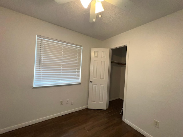 6343 Glenhagen Dr, Houston, TX 77084 - unfurnished bedroom with baseboards, dark wood-style floors, a textured ceiling, a closet, and a ceiling fan