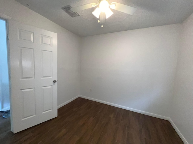 6343 Glenhagen Dr, Houston, TX 77084 - spare room featuring dark wood-type flooring, baseboards, a ceiling fan, and a textured ceiling