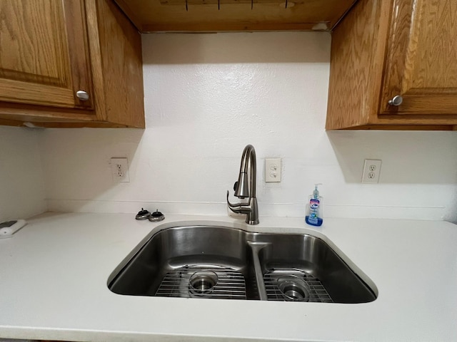 6343 Glenhagen Dr, Houston, TX 77084 - kitchen view of a sink, light countertops, and brown cabinets