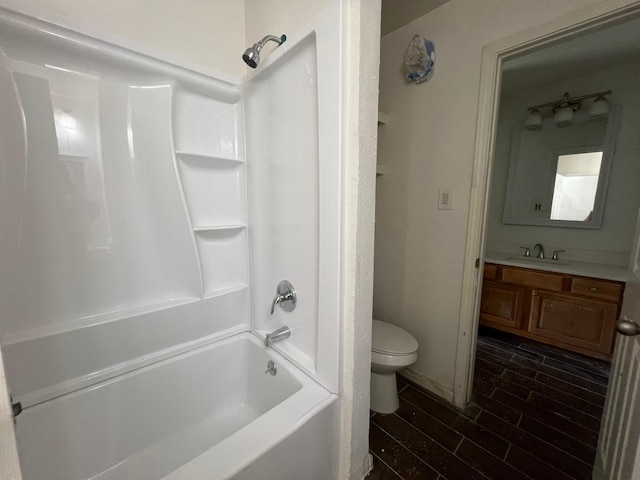 6343 Glenhagen Dr, Houston, TX 77084 - bathroom with toilet, vanity, shower / tub combination, and wood finished floors