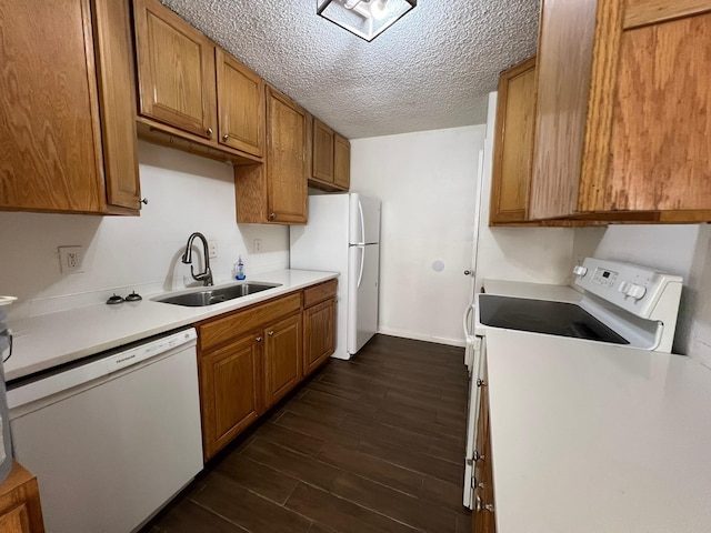 6343 Glenhagen Dr, Houston, TX 77084 - kitchen with a sink, white appliances, dark wood finished floors, light countertops, and brown cabinetry