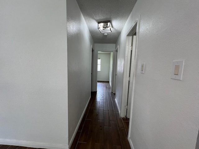 6343 Glenhagen Dr, Houston, TX 77084 - hall featuring baseboards, dark wood-style floors, and a textured ceiling