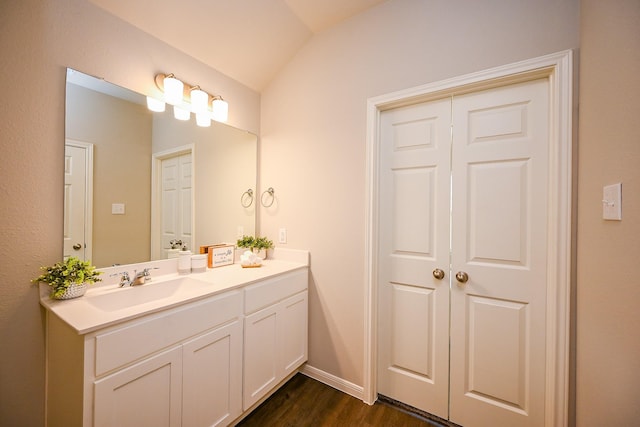10130 Barn Owl Trl, Magnolia, TX 77354 - bathroom featuring wood finished floors, vaulted ceiling, vanity, and baseboards