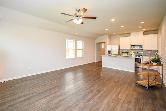10130 Barn Owl Trl, Magnolia, TX 77354 - unfurnished living room featuring a ceiling fan, lofted ceiling, dark wood-style flooring, recessed lighting, and baseboards