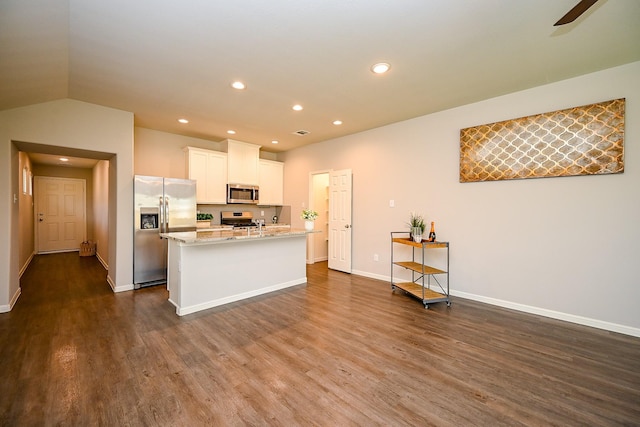 10130 Barn Owl Trl, Magnolia, TX 77354 - kitchen featuring stainless steel appliances, dark wood-style flooring, a kitchen island with sink, white cabinetry, and baseboards