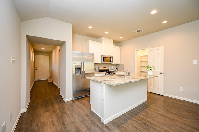 10130 Barn Owl Trl, Magnolia, TX 77354 - kitchen with appliances with stainless steel finishes, dark wood finished floors, white cabinets, a kitchen island with sink, and a sink